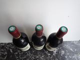 three bottles of wine sitting next to each other on a counter