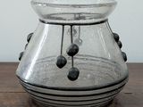 a glass vase that is sitting on a wooden table