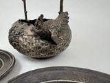 a bird that is sitting in a bowl on the table