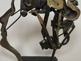 statue of a man riding a horse made of metal on a black base