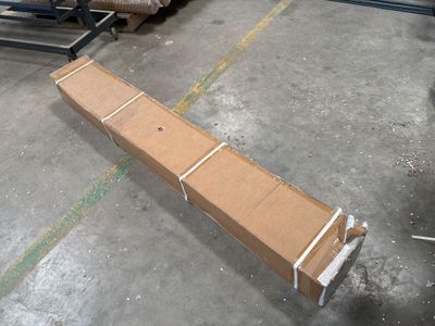 a cardboard box sitting on the floor in a warehouse