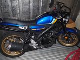 a blue motorcycle that is parked in a garage