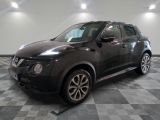 a picture of a black nissan suv parked in a garage