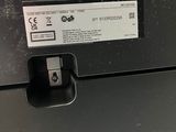 a close up of a black printer with a white label on it