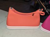 pair of pink and orange shoes sitting on top of a table
