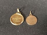 a close up of two gold coins on a black surface