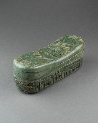 an image of a green stone box with a design on it
