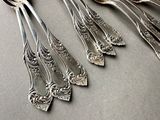 five spoons and two spoons sitting on a table