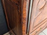 a wooden cabinet with a metal handle on top of it