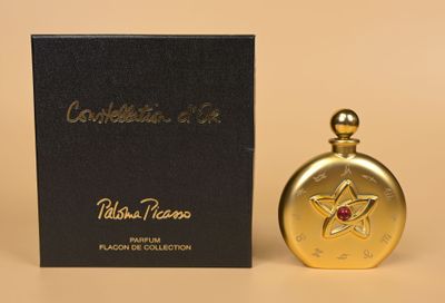 a bottle of perfume sitting next to a box on a table