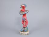 statue of a woman with a hat on her head and a bird perched on her head