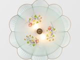 a ceiling light that has a flower design on it