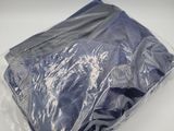 a bag of blue clothing on a white surface