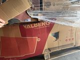 a man that is holding a box in front of a pallet