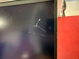 a broken tv screen sitting on a table in a room