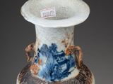 a blue and white vase with a dragon design on it