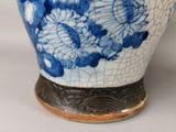 a blue and white vase sitting on a table