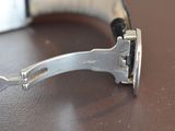 a close up of a watch on a table