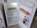 an open refrigerator and a washing machine in a kitchen