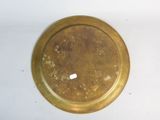 a gold plate with a white dot on it