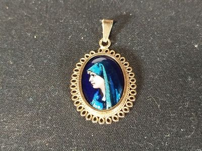 a close up of a pendant with a picture of a woman