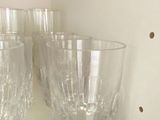 three glasses sitting on a shelf in a cabinet