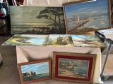 une table sur laquelle sont posés des tableaux et des photos, dans une pièce