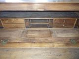 a wooden desk with a metal top in a room
