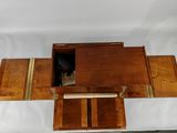 a small wooden box with a drawer inside of it