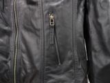 the back of a black leather jacket with zippers on it