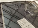 a broken windshield of a car with a paper attached to it