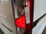 a sticker on the tail light of a white car