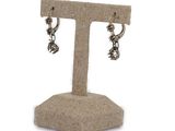 a close up of a pair of earrings on a stand