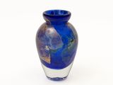 a blue vase that is sitting on a white surface
