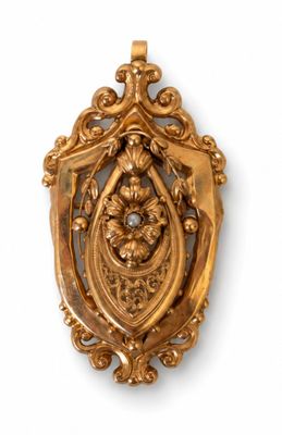 an image of a gold broochle with a bird and flowers on it