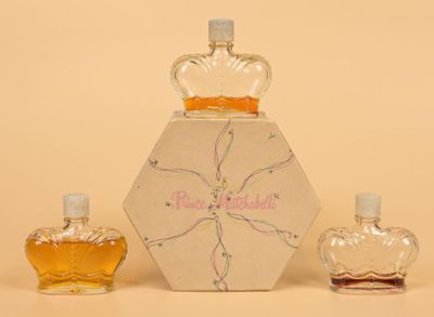 three bottles of perfume sitting next to each other on a table