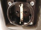 a close up of an electrical outlet on a metal pole