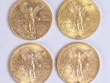 four different types of gold coins on a white surface