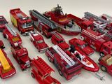a lot of toy firetrucks that are sitting on a table