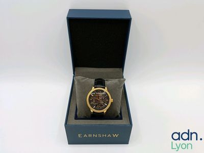 l'image d'une montre dans une boîte sur une surface blanche