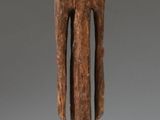 statue of a man with a head on a wooden base