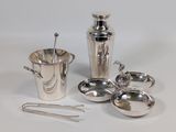 silver plated cocktail shaker with spoons, tonges, and measuring spoons
