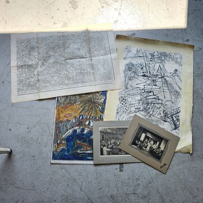 a lot of old photos on the floor next to a window