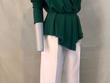 the mannequin is wearing a green top and white pants