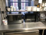 two microwaves sitting on a counter in a kitchen