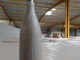 a bottle that is sitting on a table in a warehouse