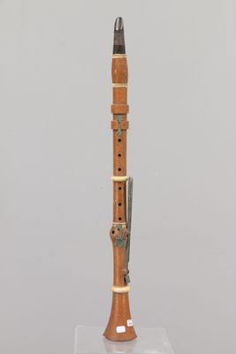 a close up of a wooden instrument on a stand on a white surface