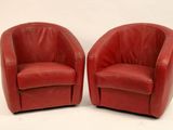 pair of red leather swivel chairs on a white background