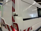 a white van with red stripes parked inside of a building