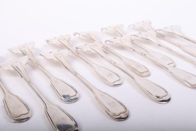 a lot of silver spoons and forks on a white surface
